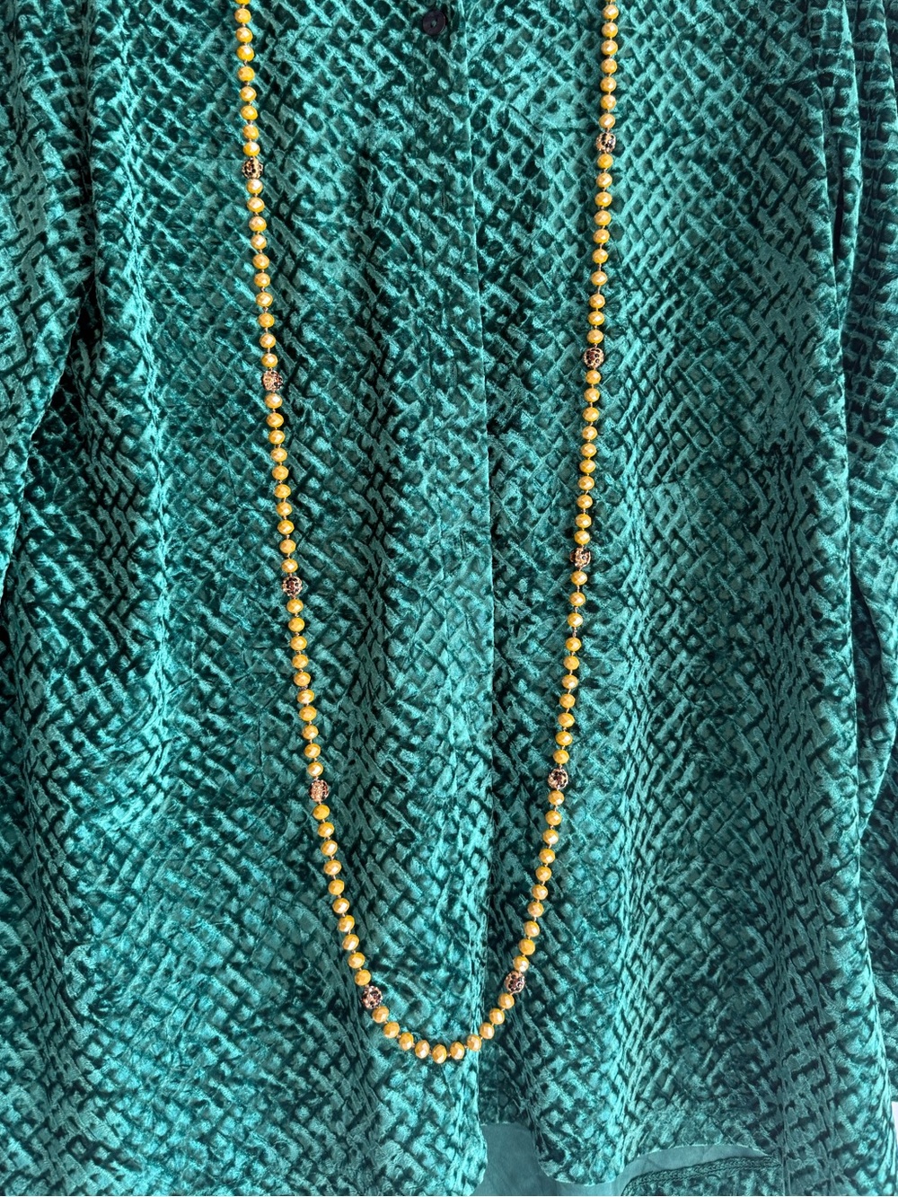 Long Gold Bead Necklace with Decorative Accents